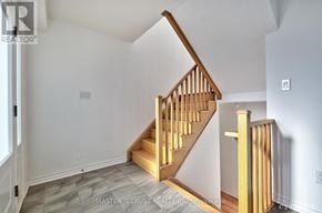 Oakville (Ga Glen Abbey) townhouse for rent - A wooden staircase with a light on the side.