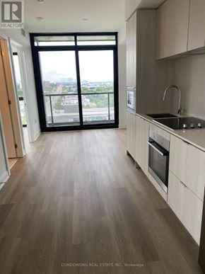 Mississauga (Cooksville) condo for rent - A kitchen with a sink, stove, and oven with a view of the city.