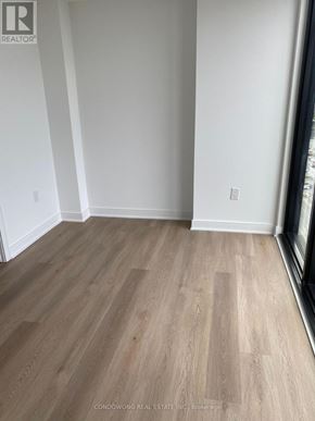 Mississauga (Cooksville) condo for rent - A room with wooden flooring and white walls.