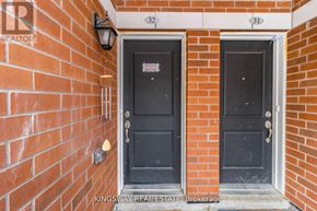 Oakville (Ro River Oaks) townhouse for rent - Two black doors are on a brick wall.
