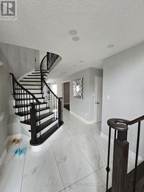 Brampton (Sandringham-Wellington) apartment for rent - A staircase with a metal railing and a wall decoration.