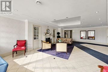 Mississauga (Rathwood) condo for rent - A spacious living room with a red chair and a blue sofa.