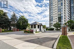 Mississauga (Rathwood) condo for rent - A residential area with a house and a tall building in the background.