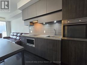 Toronto (Mount Pleasant West) condo for rent - A modern kitchen with dark wood cabinets and a stainless steel microwave.