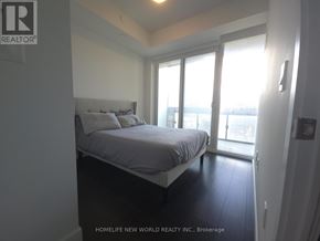 Toronto (Mount Pleasant West) condo for rent - A bedroom with a bed, nightstand, and sliding glass doors.