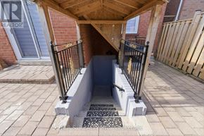Pickering (Brock Ridge) apartment for rent - A wooden covered walkway leads to a doorway.