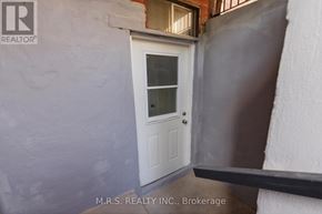 Pickering (Brock Ridge) apartment for rent - A white door with a glass window is set in a grey wall.