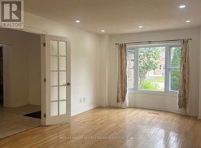 Barrie (Grove East) apartment for rent - A room with a door and a window with a view of a tree and a building outside.