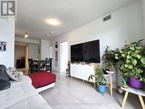 Toronto (Agincourt South-Malvern West) condo for rent - A living room with a grey couch and a red pillow.