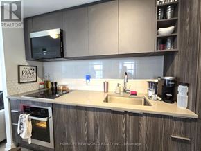 Toronto (Agincourt South-Malvern West) condo for rent - A kitchen with a sink, stove, and cabinets.