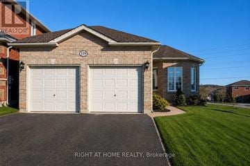 Barrie (East Bayfield) apartment for rent - A two-car garage is attached to a brick house.