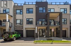 Burlington (Lasalle) townhouse for rent - A green jeep is parked in front of a modern two-story building.