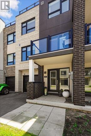 Burlington (Lasalle) townhouse for rent - A modern apartment building with a green car parked in front.