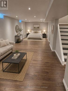 Hamilton (Stoney Creek) apartment for rent - A spacious bedroom with a staircase on the right side.