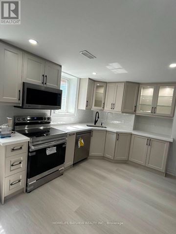 Bradford West Gwillimbury (Bradford) apartment for rent - A kitchen with a stove top oven and microwave.