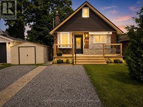 Niagara Falls (Dorchester) apartment for rent - A house with a front yard and a driveway.