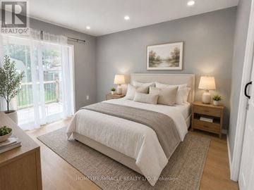 Niagara Falls (Dorchester) apartment for rent - A well-lit bedroom with a large bed and a painting on the wall.