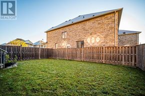 Brampton (Bram East) apartment for rent - A house with a wooden fence and a green lawn in front.