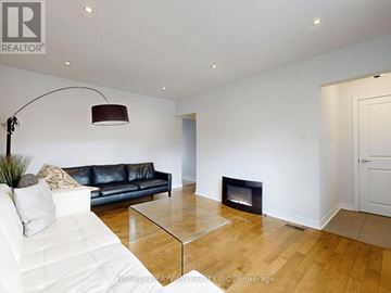 Toronto (Willowdale West) apartment for rent - A living room with a black leather couch and a glass coffee table.