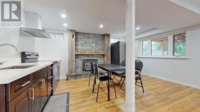 Mississauga (Erin Mills) apartment for rent - A kitchen with a fireplace and a dining table.