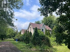 East Gwillimbury apartment for rent - A house with a brown roof is surrounded by greenery.