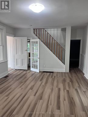 East Gwillimbury apartment for rent - A room with wooden flooring and a staircase.