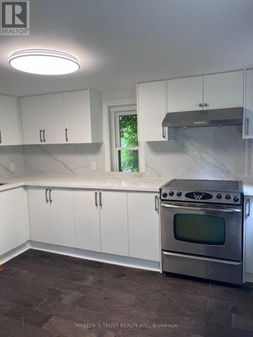 East Gwillimbury apartment for rent - A kitchen with white cabinets and a stainless steel oven.