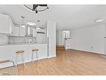 Gatineau (Gatineau) condo for rent - A kitchen with white cabinets and a bar stool.