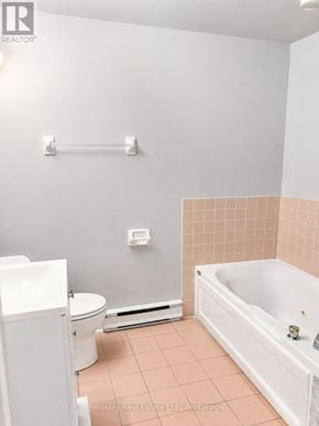 Collingwood townhouse for rent - A white toilet sits next to a white sink in a small bathroom.