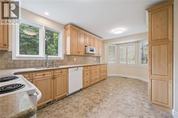 Cambridge townhouse for rent - A kitchen with wooden cabinets and a tiled floor.