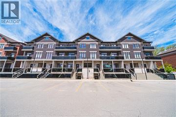 Burlington townhouse for rent - A large apartment complex with multiple buildings and parking spaces in front.