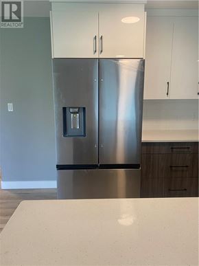 Azilda apartment for rent - A stainless steel refrigerator with a water dispenser on the door.