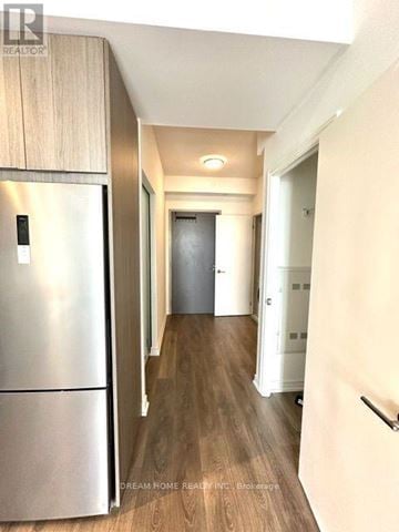 Toronto (Henry Farm) condo for rent - A modern kitchen with a stainless steel refrigerator and wooden flooring.