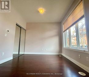 Markham (Commerce Valley) townhouse for rent - A room with a wooden floor and a window with blinds.