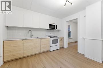 Brantford apartment for rent - A kitchen with wooden cabinets and a white oven.