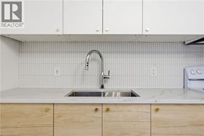 Brantford apartment for rent - A kitchen with a sink and cabinets.