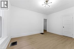 Brantford apartment for rent - A room with a ceiling fan and a door.