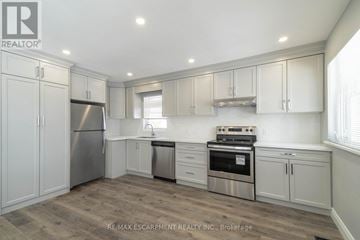 Hamilton (Westcliffe) apartment for rent - A kitchen with white cabinets and stainless steel appliances.