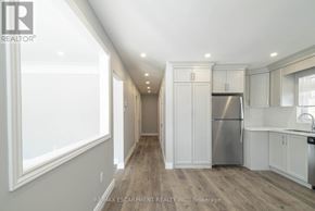 Hamilton (Westcliffe) apartment for rent - A well-lit kitchen with white cabinets and a stainless steel refrigerator.