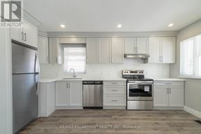 Hamilton (Westcliffe) apartment for rent - A kitchen with white cabinets and stainless steel appliances.