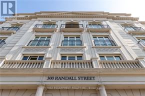 Oakville (Oo Old Oakville) condo for rent - The image shows the front of a building with the sign "300 Randall Street" and "RE/MAX Escarpment Realty Inc., Brokerage" on it.