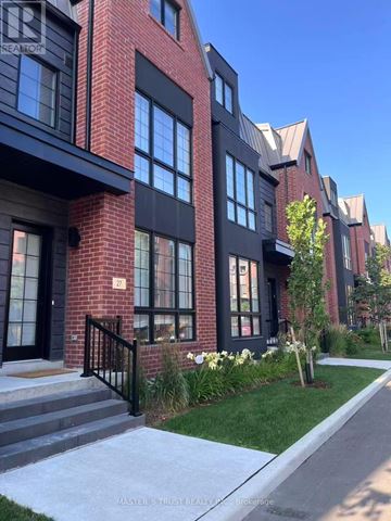 Vaughan (Uplands) townhouse for rent - A row of red brick houses with black windows and doors.