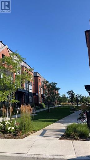 Vaughan (Uplands) townhouse for rent - A row of red brick buildings with a sidewalk in front.