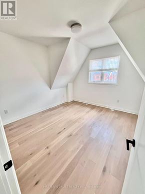 Vaughan (Uplands) townhouse for rent - A room with wooden flooring and a window with blinds.