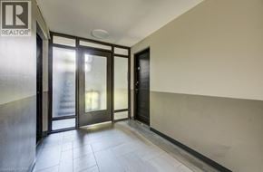 London apartment for rent - A hallway with a glass door and a black door.