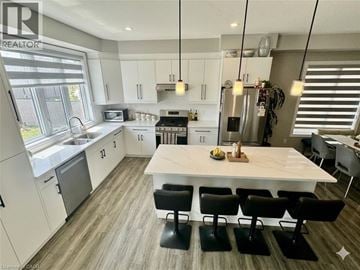 Kitchener apartment for rent - A modern kitchen with a dining table and chairs.