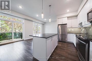 Burlington (Brant) townhouse for rent - A modern kitchen with white cabinets and a stainless steel refrigerator.