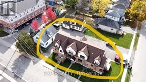 Brampton (Downtown Brampton) multi-family for rent - An aerial view of a neighborhood with a yellow circle highlighting a house for sale.