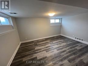 Brampton (Downtown Brampton) multi-family for rent - A room with wooden flooring and a window.