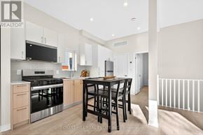 Toronto (Banbury-Don Mills) apartment for rent - A modern kitchen with a dining table and chairs.